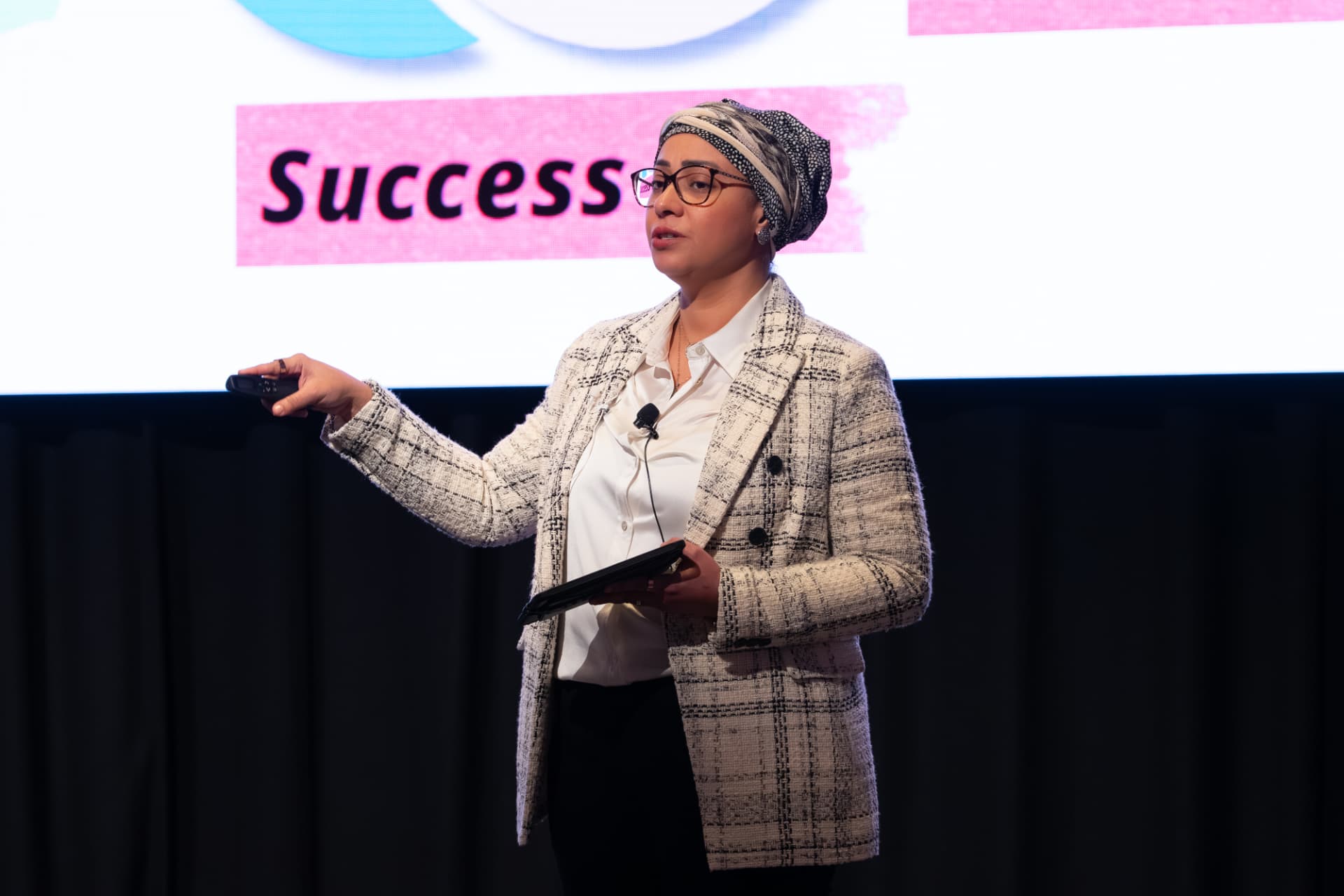 Jess Tayel speaking on stage about success